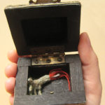 Severed Hand in Box Knitted severed hand with blood and bone