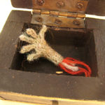 Severed Hand in Box Knitted severed hand with blood and bone