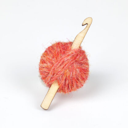 flame ball of wool with crochet hook on a white background