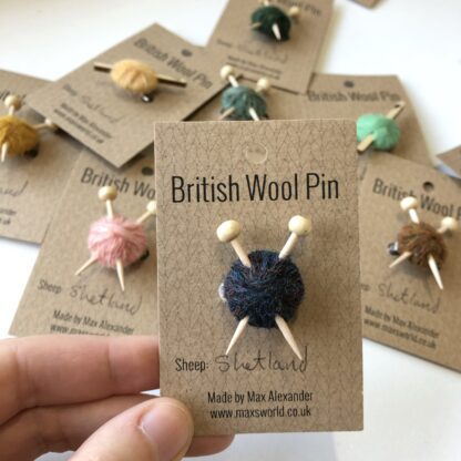 Pins made from balls of wool with either knitting needles or a crochet hook in.